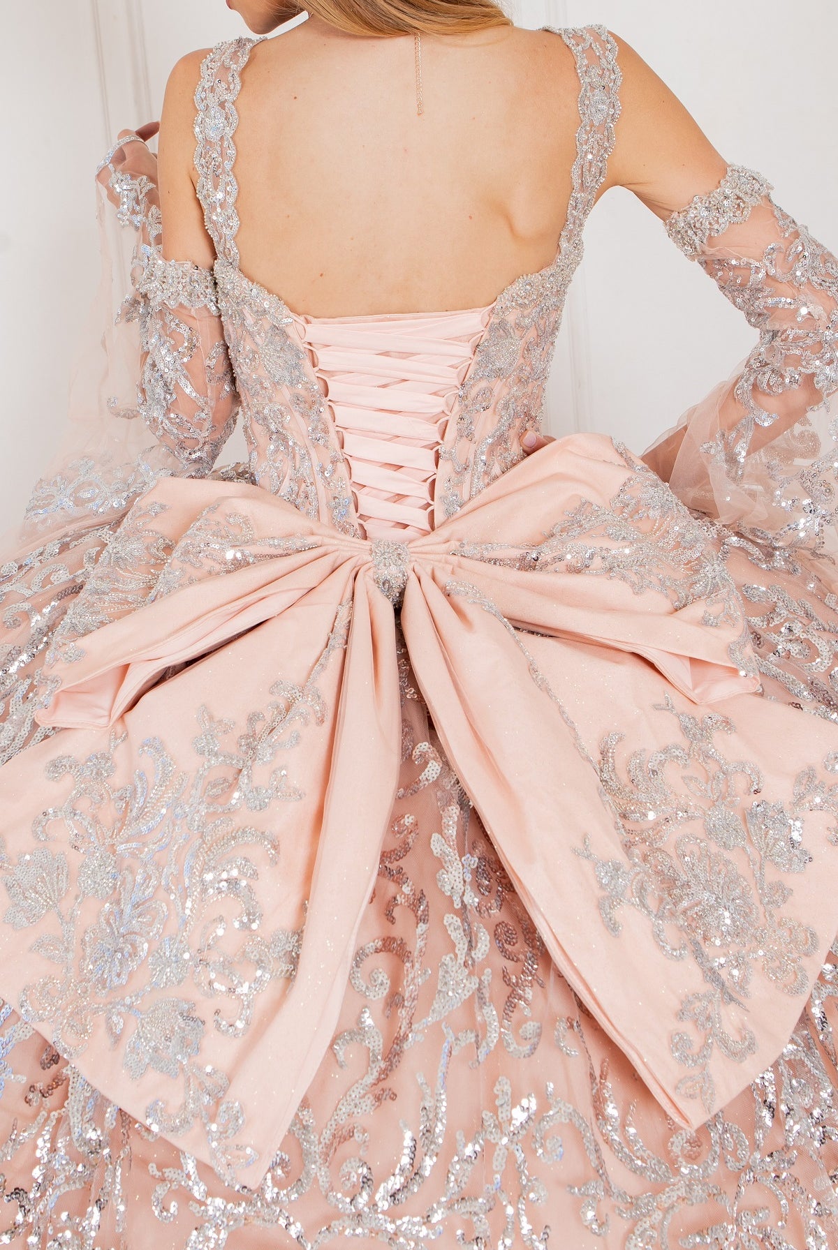 A closer look at the back of rose quinceanera dress with sleeves
