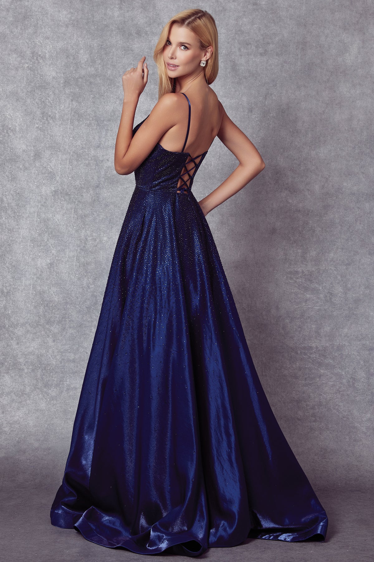 Back of navy blue prom gown with stone accents