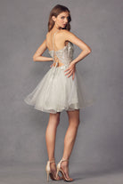 Back of silver short dress with butterfly appliques