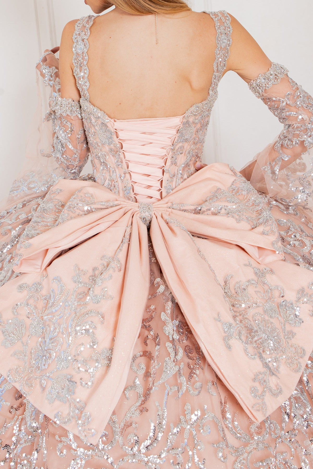 A closer look at the back of rose quinceanera dress with sleeves